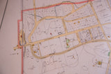Antique Larchmont map detail showing Roosevelt Avenue, railroad, and property lines in cream and red.