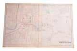 Antique map of the Village of White Plains showing a historical street grid with colored property plots.