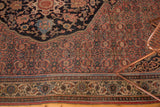 Superb curvilinear detail in the terracotta and blue border of an antique Persian Bijar rug.