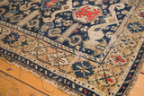 Antique Perpedil Caucasian rug corner detail, navy field, geometric rams horn motifs, tattered edge.