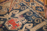 Antique Perpedil Caucasian rug's geometric rams horn motifs in navy, beige, and burnt orange.