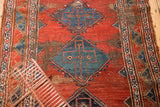Early 20th century Bijar rug, blue diamond medallion, and cherry red field with foundation wear.