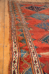 Detailed side of antique Bijar runner, highlighting geometric border and tattered foundation.