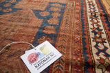 Antique Caucasian rug's geometric star and crab border in indigo blue and madder root red.