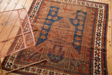 Antique Caucasian prayer niche rug: geometric motifs, star crab border, madder red, indigo.