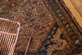 Hand-knotted vintage Dargezine rug's burnt blush herati motif and navy border.