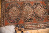 Antique Qashqai rug's central medallions display animals, plants, and pinwheel motifs.