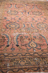 Mahal carpet detail: dusty blush rose field, ornate teal motifs, and visible patina.