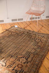 Parallel striped field with water motif and geometric border on vintage Kamseh rug.