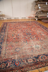 Intricate blue floral border on the vintage Mahal carpet, blending into a faded coral field.