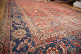 Vintage Mahal carpet corner detail, showing navy border with muted red curvilinear floral design.
