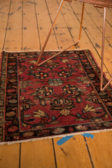 Vintage Lilihan rug corner featuring cherry red floral palmettes, secured fringe, and tattered side.