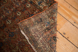 Hand-knotted foundation, secured burnt orange edge, and tattered fringe of a vintage Hamadan rug.