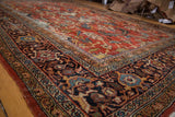 Vintage Mahalati carpet corner with deep borders, sky blue, saffron yellow, and brick patterns.