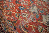 Articulated palmettes and tendrils with visible wear on a vintage Mahalati carpet.