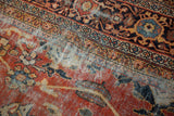 Worn burnt orange field of Mahalati carpet, featuring scrolling palmettes and exposed foundation.