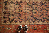 Antique Hamadan rug field revealing allover floral botehs, indigo ground, and considerable pile wear.