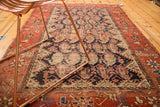 Antique Hamadan rug's indigo field of floral botehs and wide madder root red vinery border.