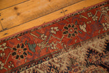 Worn section of antique Hamadan rug displaying foundation, madder root red, and blue floral motifs.