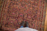 Antique Karabagh rug's intricate Herati pattern in plum, madder red, and ink blue wool pile.
