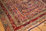 Detailed corner of antique Karabagh runner, hand-knotted borders featuring madder red, ink blue, and ivory.