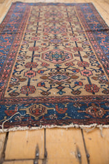 Rich indigo blue border with geometric motifs and tattered fringe of Persian Hamadan rug.
