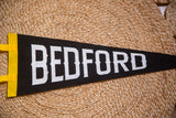 Bedford felt pennant with textured white letters and a vibrant yellow side.