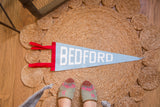 Bedford NY felt pennant flag, baby blue with white BEDFORD letters and red side.