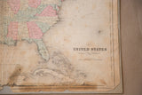 Detail of antique Rand McNally USA map with 'UNITED STATES' title and age wear.