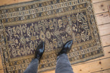 A top-down look at the vintage Shirvan rug's intricate star border and low, even wear.