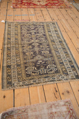 A vintage Shirvan rug with classic Perpedil style design shown at an angle.