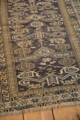 Angled view of a vintage Shirvan rug's Perpedil motifs and even wear to knot heads.