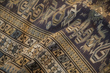 Low-pile texture showing the repeating pawn design border on a vintage Shirvan rug.