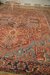Intricate blue border and cherry red field on antique Heriz rug, with original multi-color selvage.