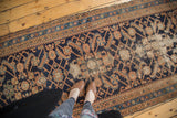 Vintage Hamadan runner's geometric Herati pattern, dark navy blue field, localized foundation wear.