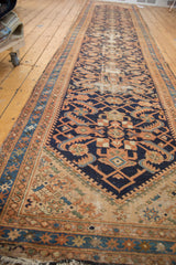Vintage Hamadan runner displaying geometric herati design on navy field with localized wear.