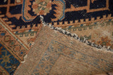Hand-knotted vintage Hamadan rug showing dark navy herati pattern, visible foundation, and wear.
