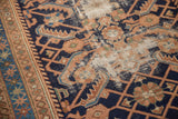 Vintage Hamadan rug runner featuring navy blue Herati design with visible foundation wear.