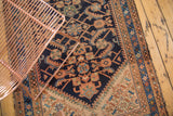 Vintage Hamadan runner: dark indigo geometric herati pattern with pale terra cotta and wear.