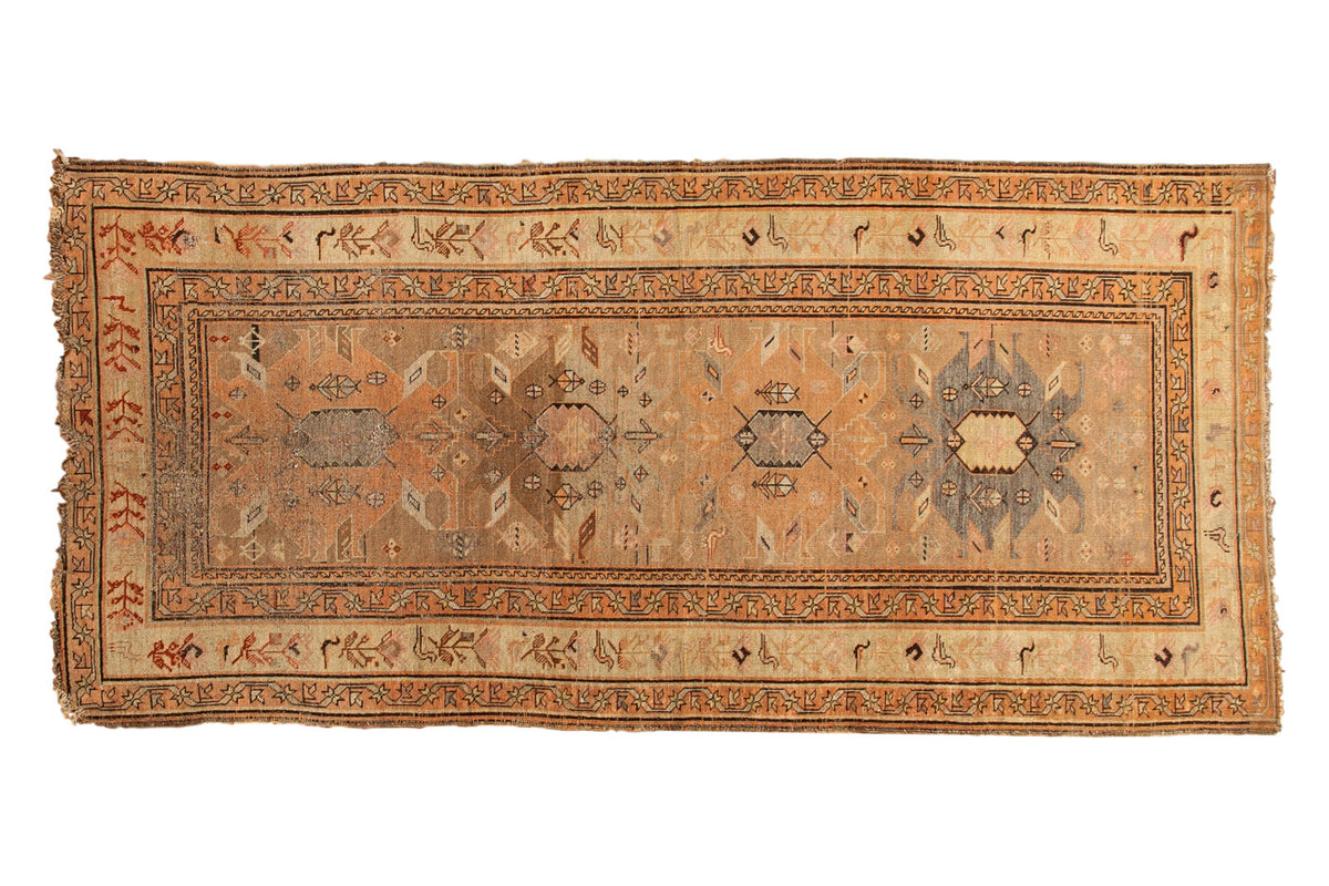 Antique Caucasian runner with geometric palmettes, border birds, in faded saffron, charcoal, and blush colors.