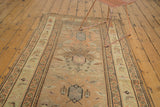 Tattered end of antique Caucasian runner, geometric border with bird motifs.