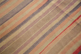 Textural detail of vintage Turkish Kilim showcasing varied stripes, muted hues, and color shifts.