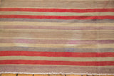 Faded cherry red, sea foam green, and ivory horizontal stripes on a Turkish Kilim, with fringe.