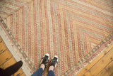 Vintage Turkish Jijim carpet's repeating parallel diamond pattern in warm reds, tangerine, and slate blue.