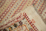Vintage Turkish jijim carpet's hand-woven flat weave, patterned edge, and diamond motifs.