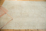 Subtle tone-on-tone snow white and pale beige patterns on a vintage Turkish Oushak rug.