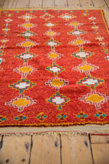 Plush pile vintage Moroccan rug, geometric diamond motifs in pomegranate red, orange, ivory, aqua.