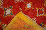 Hand-knotted vintage Moroccan rug, plush red pile with geometric pattern, striped reverse.