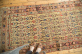 Antique Kurdish Bijar rug corner with pale saffron field and geometric terra cotta borders.