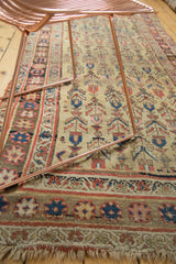 Antique Kurdish Bijar rug: pale saffron field with geometric trees, ornate border, and aged fringe.